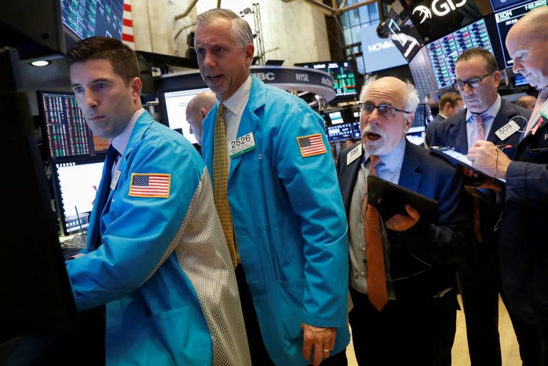 Traders work on the floor at the NYSE in New York