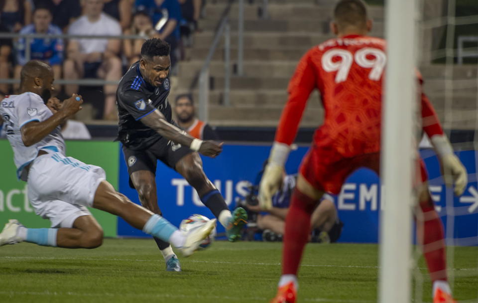 CF Montreal's Romell Quioto, second from right, drives the ball to the net of New England Revolution goalie Djordje Petrovic (99) during first-half MLS soccer match action in Montreal, Saturday, Aug. 20, 2022. (Peter McCabe/The Canadian Press via AP)