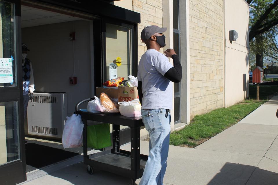 A worker takes out food for distribution at the Broad Street Presbyterian Church food pantry on May 9, 2022.