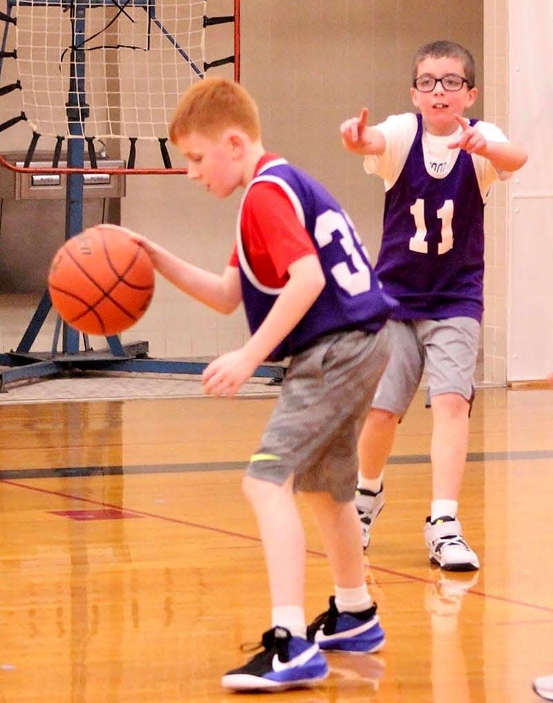 Ethan Schwartz (11) of the Lakers calls for the ball while teammate Nolan Diehl (34) shows off his ball handling skills during a recent Honesdale Biddy Basketball Association contest.
