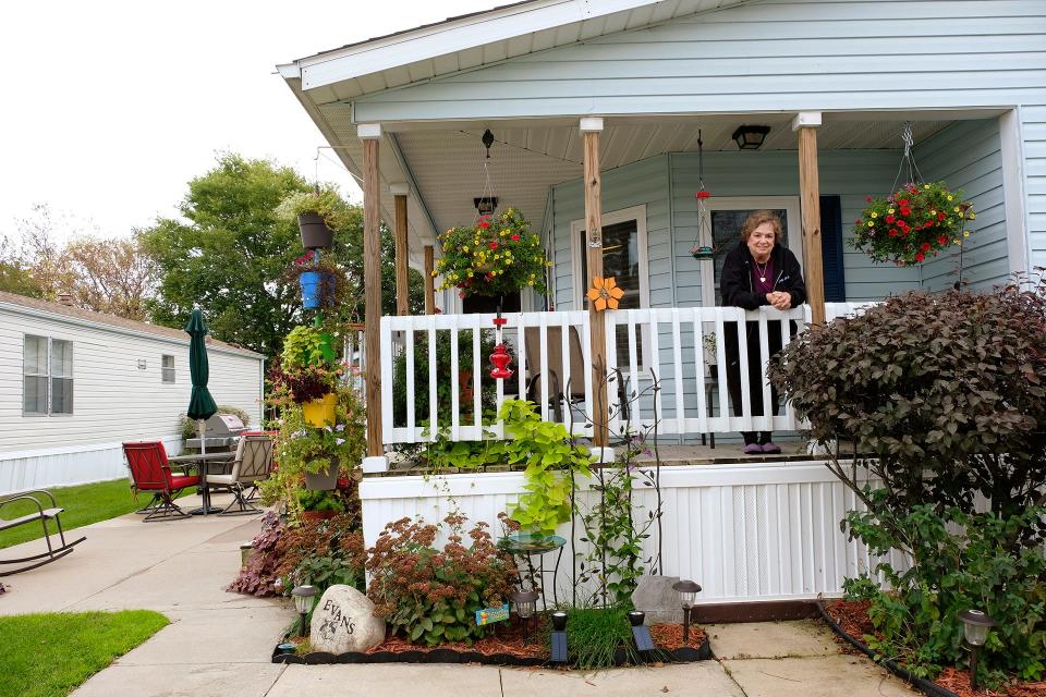 Candi Evans leans over the balcony of her home in Golfview Mobile Home Park in North Liberty in a scene from the documentary "A Decent Home." The film will be shown April 27 and 28 in Iowa City.