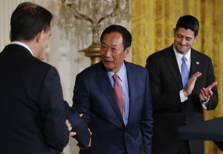 Foxconn Chairman Terry Gou (C) greets Wisconsin Governor Scott Walker (L) as House Speaker Paul Ryan (R-WI) applauds during a White House event where the Taiwanese electronics manufacturer Foxconn announced plans to build a $10 billion dollar LCD display panel screen plant in Wisconsin, in Washington, U.S., July 26, 2017. REUTERS/Jonathan Ernst