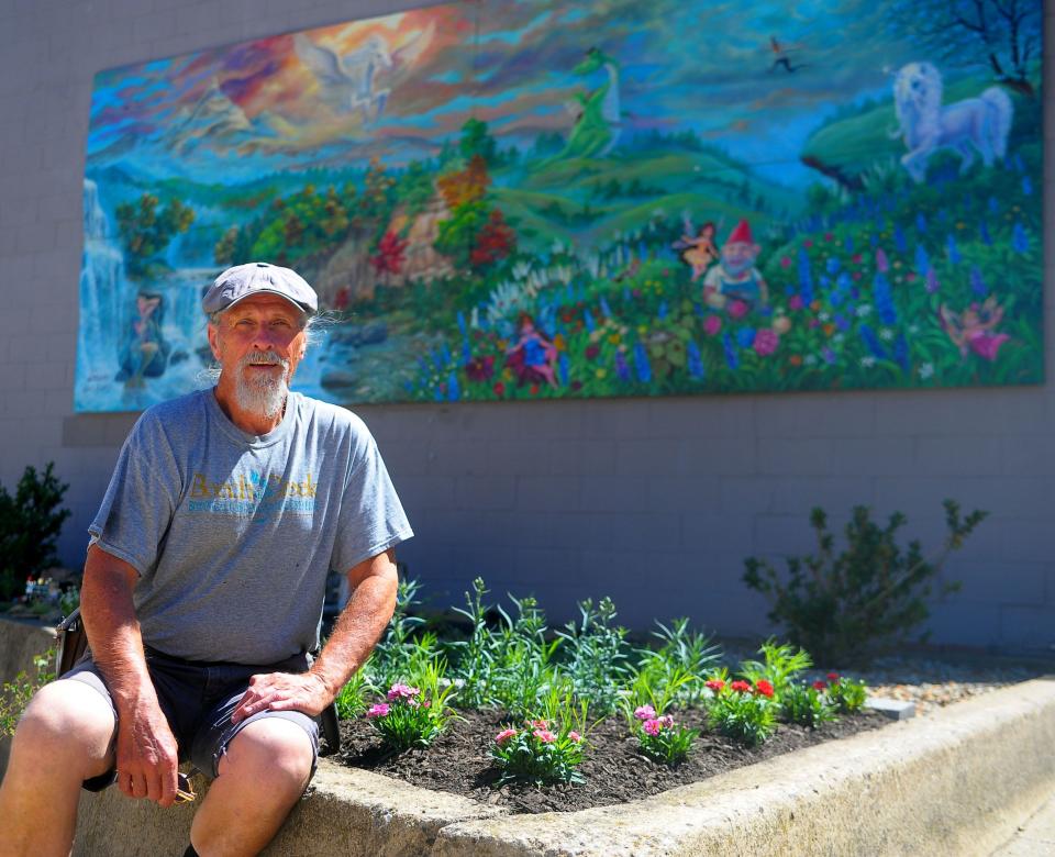 Paul Carmichael sits Saturday, June 15, 2024, by a carnation garden he planted in downtown Alliance for participants taking the East Main Street Historic District Walking Tour to enjoy.