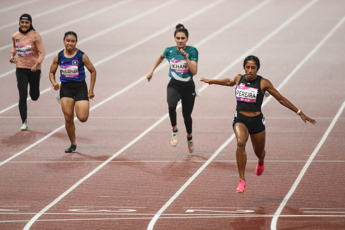 Singapore sprinter Shanti Pereira crosses the finish line in her women's 100m heat at the 2023 Hangzhou Asian Games. She has qualified for the final. (PHOTO: Sport Singapore/ Weixiang Lim)