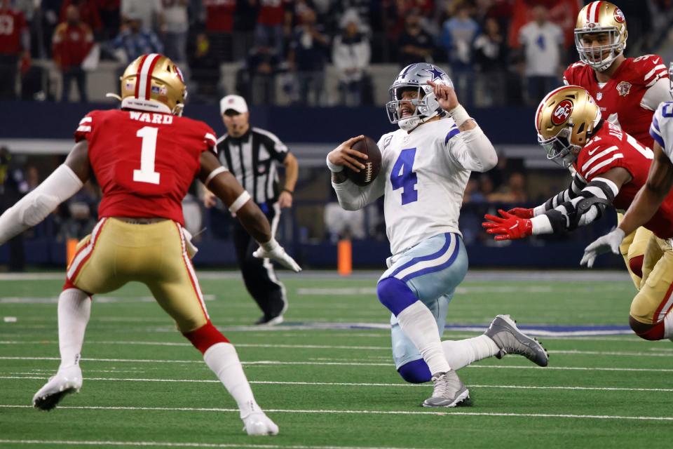 Cowboys quarterback Dak Prescott slides after running the ball with seconds remaining Sunday against the 49ers.