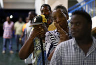 <p>Barbuda resident Diamn Beazer (third in line) waits for food at a shelter in the Sir Vivian Richards Cricket Stadium on Sept. 20, 2017 in North Sound, Antigua and Barbuda. Refugees from the island of Barbuda are been housed after the government ordered a mandatory evacuation in response to Hurricane Irma’s devastation of the Caribbean Island. (Photo: Jose Jimenez/Getty Images) </p>