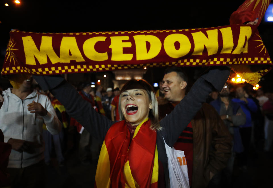 A supporter of a movement for voters to boycott the referendum, celebrates in central Skopje, Macedonia, after election officials gave low turnout figures, Sunday, Sept. 30, 2018. The crucial referendum on accepting a deal with Greece to change the country's name to North Macedonia to pave the way for NATO membership attracted tepid voter participation Sunday, a blow to Prime Minister Zoran Zaev's hopes for a strong message of support. (AP Photo/Thanassis Stavrakis)