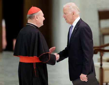 U.S. Vice President Joe Biden (R) shakes hands with cardinal Gianfranco Ravasi following his speech in Paul VI hall at the Vatican April 29, 2016. REUTERS/Max Rossi