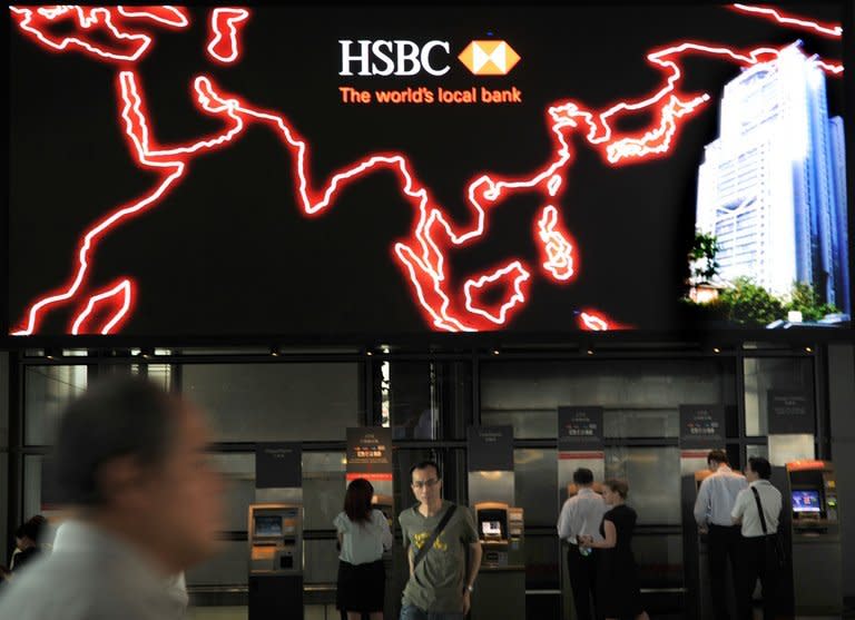 File photo shows people using ATM machines at the HSBC headquarters in Hong Kong. In early November HSBC said it had set aside $1.5 billion for fines linked to money-laundering in the United States