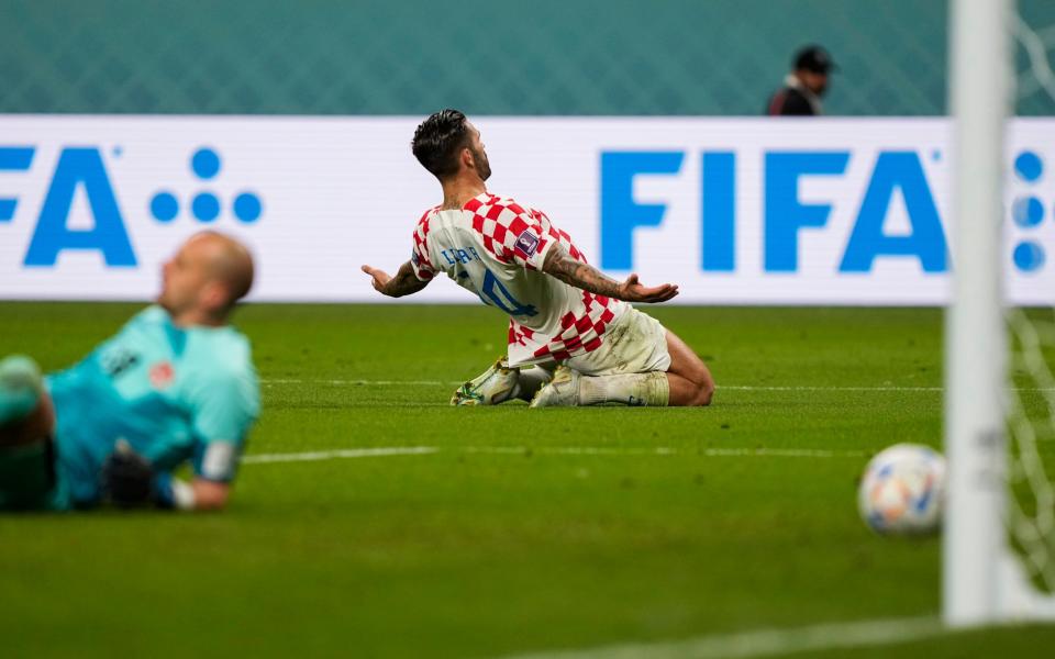 Croatia's Marko Livaja celebrates after scoring his side's second goal past Canada's goalkeeper Milan Borjan, left, during the World Cup group F soccer match between Croatia and Canada - Martin Meissner/AP