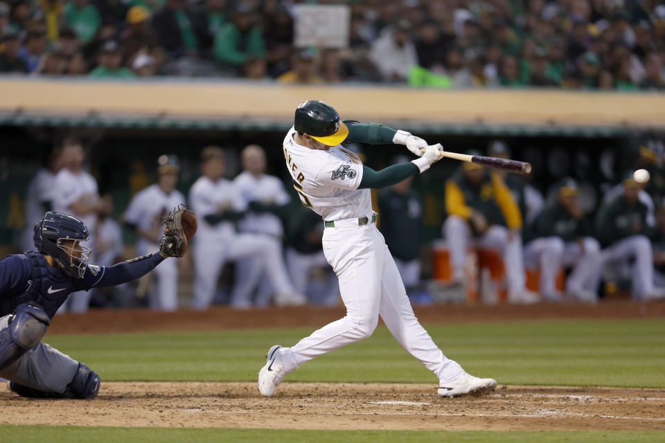 Oakland Athletics' Brent Rooker hits an RBI double in front of Tampa Bay Rays catcher Francisco Mejia during the seventh inning of a baseball game in Oakland, Calif., Tuesday, June 13, 2023. (AP Photo/Jed Jacobsohn)
