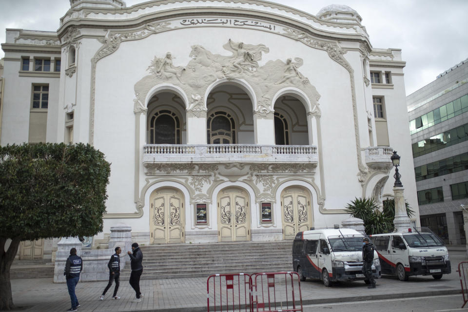 Security forces stand guard in Tunis' landmark Avenue Habib Bourgiba, where massive protests took place in 2011, on the tenth anniversary of the uprising, during a national lockdown after a surge in Covid-19 cases, in Tunis, Thursday, Jan. 14, 2021. Tunisia is commemorating the 10th anniversary since the flight into exile of its iron-fisted leader, Zine El Abidine Ben Ali, pushed from power in a popular revolt that foreshadowed the so-called Arab Spring. But there will be no festive celebrations Thursday marking the revolution in this North African nation, ordered into lockdown to contain the coronavirus. (AP Photo/Mosa'ab Elshamy)