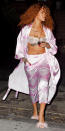 <p>RiRi grabbed a drink and hit the streets in silky pink PJ pants and a matching robe, exposing her sheer white lace bra (shop a similar look <a rel="nofollow noopener" href="https://www.net-a-porter.com/us/en/product/822373?" target="_blank" data-ylk="slk:here;elm:context_link;itc:0;sec:content-canvas" class="link ">here</a>). The notorious bad gal completed the ensemble with a pair of furry pale pink sandals (shop a similar look <a rel="nofollow noopener" href="https://www.macys.com/shop/product/chinese-laundry-jannet-pom-pom-sandals?ID=4324966&" target="_blank" data-ylk="slk:here;elm:context_link;itc:0;sec:content-canvas" class="link ">here</a>) and several gold chains. </p>