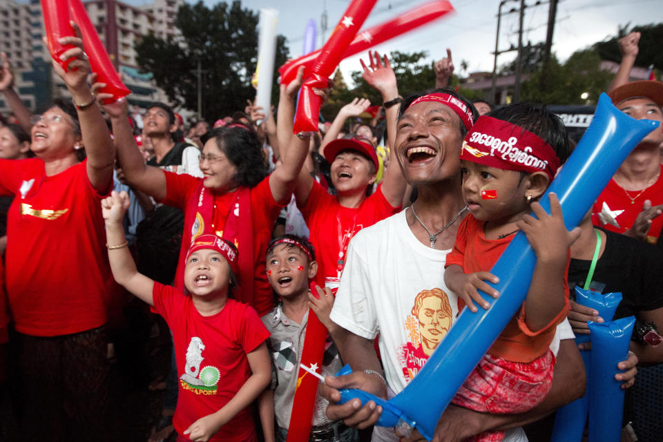 FILE - Supporters of Myanmar's National League for Democracy party cheer as election results are posted outside the NLD headquarters in Yangon, Myanmar on Nov. 9, 2015. Myanmar court on Monday, Dec. 6, 2021, sentenced ousted leader Suu Kyi to 4 years for incitement and breaking virus restrictions, then later in the day state TV announced that the country's military leader reduced the sentence by two years. (AP Photo/Mark Baker, File)