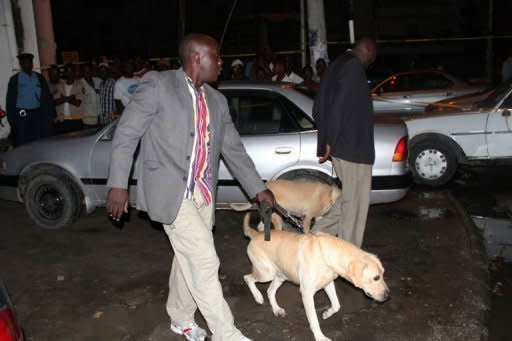 Kenyan police officers arrive with sniffer dogs late on May 15, 2012 at the scene of a grenade attack in the coastal city of Mombasa in which one person was killed when it was thrown at a crowded restaurant. Kenya police have arrested a man suspected to have taken part in the grenade attack, police chief Mathew Iteere said Wednesday