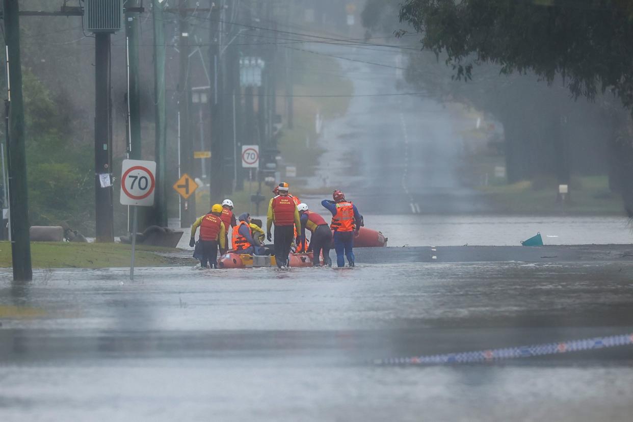 A family is evacuated by State Emergency Service workers due to rising floodwaters in Bligh Park on July 4, 2022 in Sydney, Australia. 
