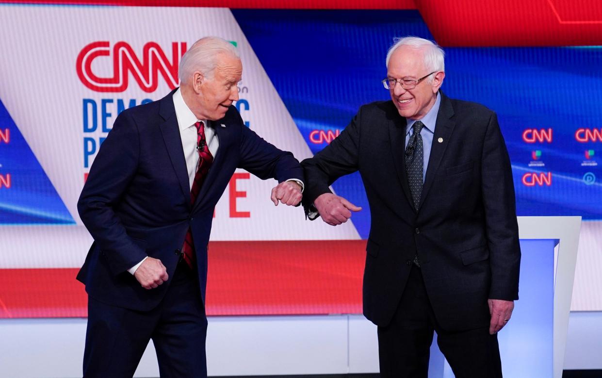 Joe Biden and Bernie Sanders, the Left-wing Democratic senator on CNN in 2020. Executives believe the network's liberal shift in recent years has alienated viewers - AP