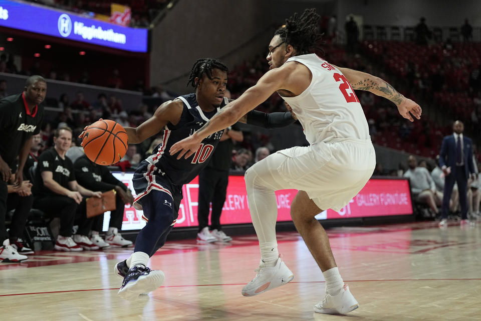 Jackson State guard Chase Adams (10) tries to work past Houston guard Emanuel Sharp (21) during the first half of an NCAA college basketball game, Saturday, Dec. 9, 2023, in Houston. (AP Photo/Kevin M. Cox)