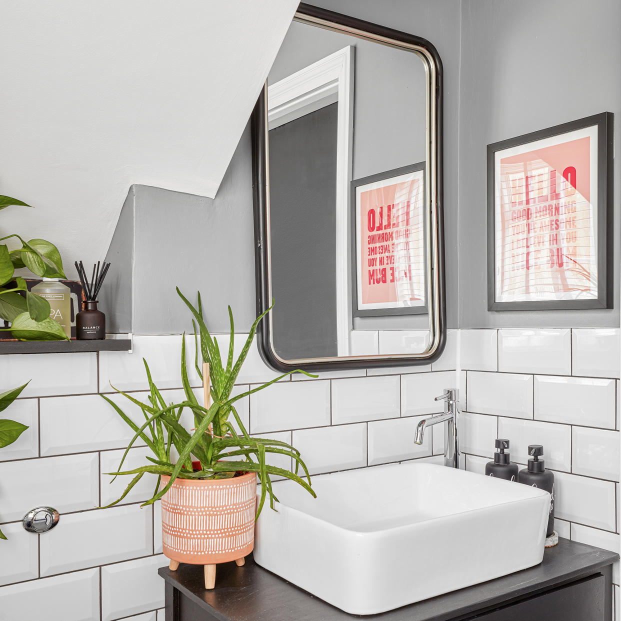  Small washroom with grey walls, metro tiles, mirror and sink 