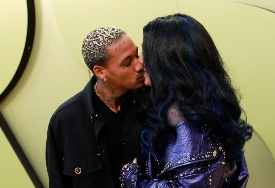 The pair sealed it with a kiss in front of photographers (AFP via Getty Images)