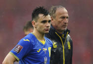 Ukraine's Mykola Shaparenko and manager Oleksandr Petrakov react following the World Cup 2022 play-off final soccer match at Cardiff City Stadium, Cardiff, Wales, Sunday June 5, 2022. Wales won 1-0. (Mike Egerton/PA via AP)