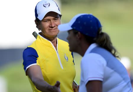 Aug 19, 2017; West Des Moines, IA, USA; Europe golfer Catriona Matthew shakes hands with USA golfer Cristie Kerr on the 17th green during the second day of The Solheim Cup international golf tournament at Des Moines Golf and Country Club. Thomas J. Russo-USA TODAY Sports