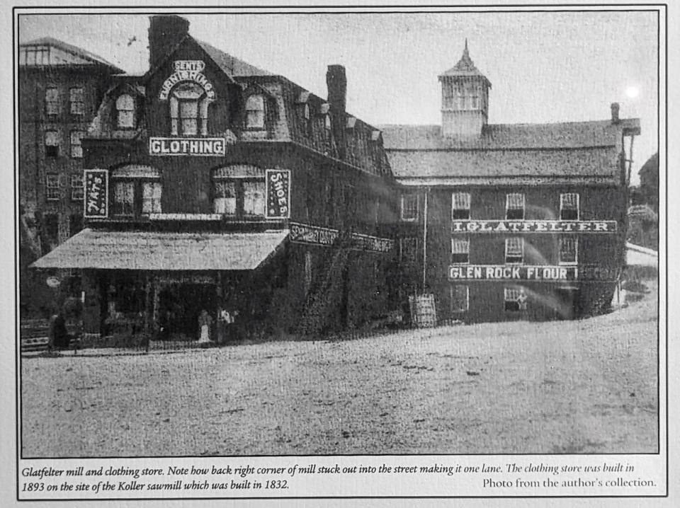 An early photo shows the  Wherley building with its original facade and the original windows in the mill building. In the 1980s, the building was also shortened 15 feet at right to make Route 216 two lanes during a major renovation project.