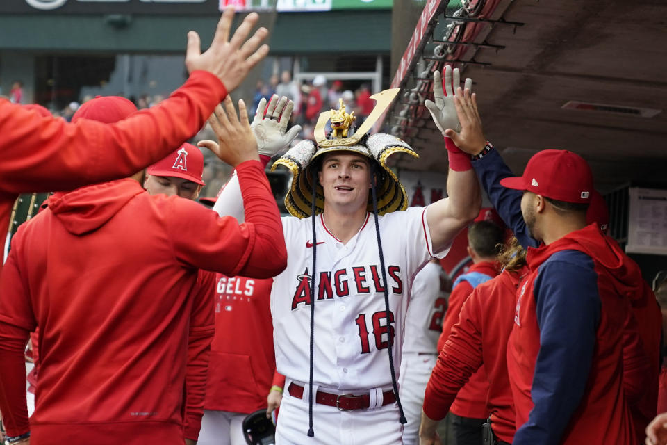 Los Angeles Angels' Mickey Moniak (16) celebrates in the dugout after hitting a home run during the first inning of a baseball game against the Boston Red Sox in Anaheim, Calif., Tuesday, May 23, 2023. (AP Photo/Ashley Landis)