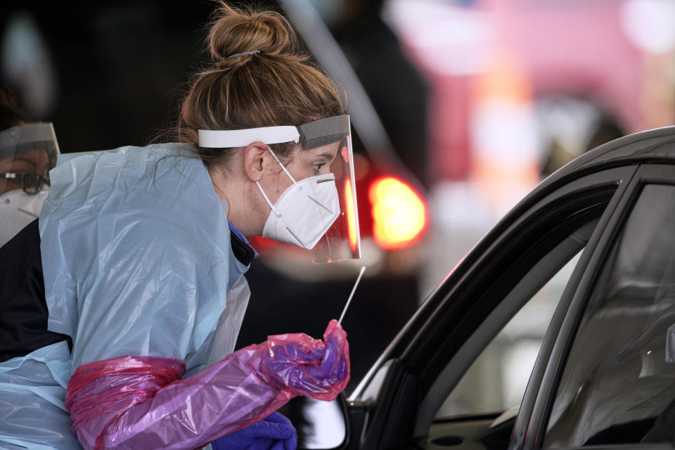 A nurse at a drive-thru location in Omaha, Neb., holds a swab as she prepares to administer a test for the coronavirus, Monday, May 4, 2020. (Nati Harnik/AP)