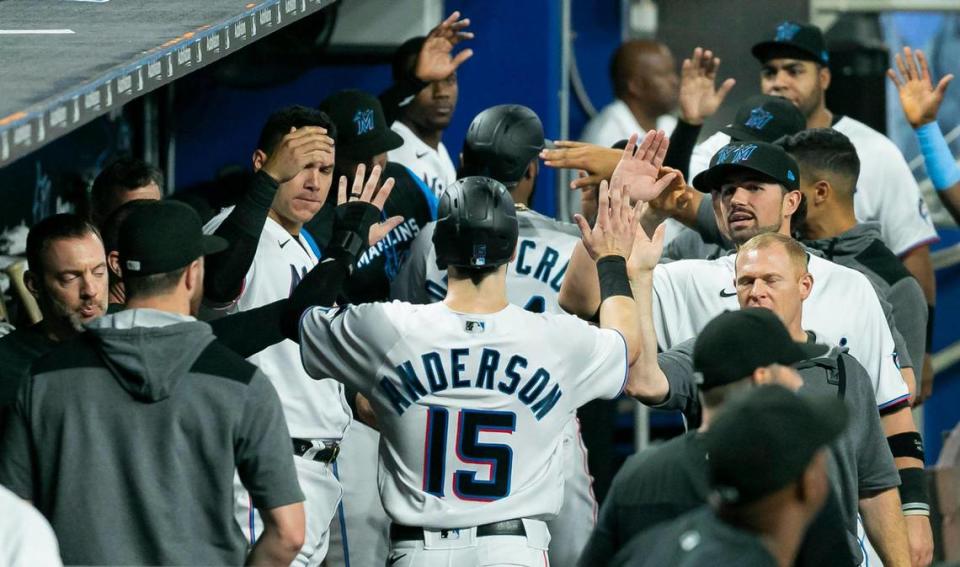 Miami Marlins third baseman Brian Anderson (15) celebrates after scoring a run against the Washington Nationals during the second inning of their baseball game at LoanDepot Park on Monday, May 16, 2022, in Miami, Florida.