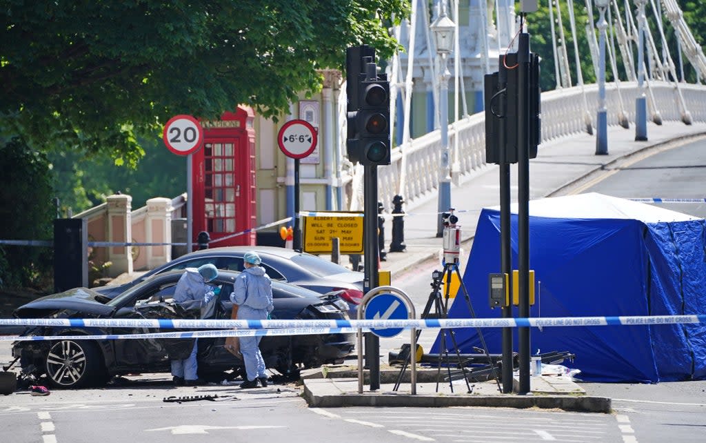 Police forensic officers at the scene at Cheyne Walk in Chelsea, London, after a 41-year-old woman and three dogs have been killed following a car crash.  (PA)