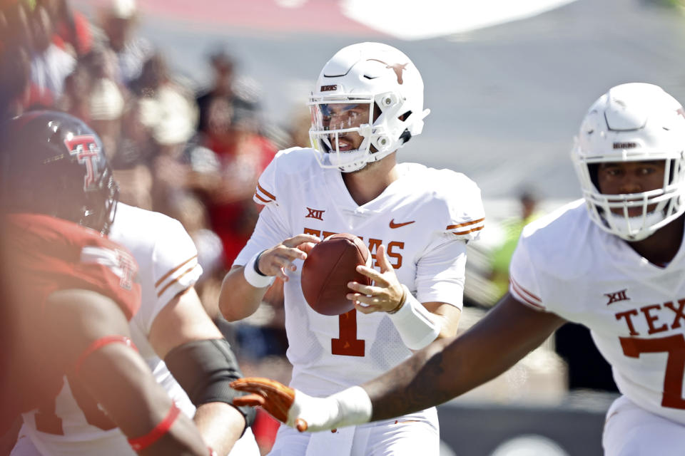 Texas' Hudson Card (1) drops back to pass the ball during the first half of an NCAA college football game against Texas Tech, Saturday, Sept. 24, 2022, in Lubbock, Texas. (AP Photo/Brad Tollefson)