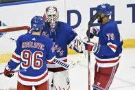 New York Rangers goaltender Igor Shesterkin, center, celebrates with Jack Roslovic (96) and K'Andre Miller (79) after they shut out the Ottawa Senators in an NHL hockey game Monday, April 15, 2024, at Madison Square Garden in New York. (AP Photo/Bill Kostroun)