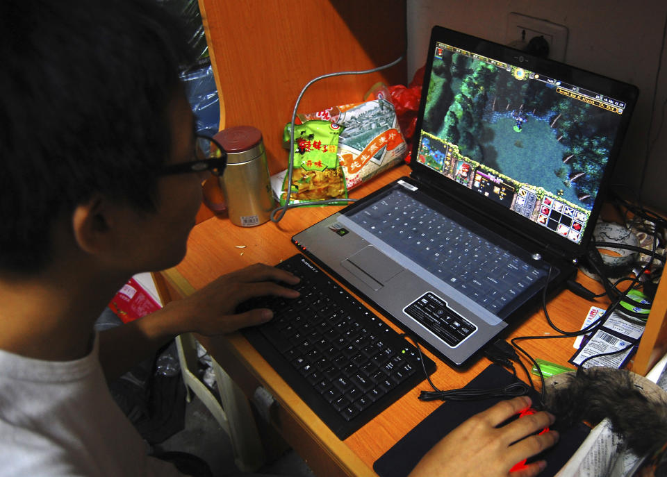 FILE - A college student plays the online game World of Warcraft in his dormitory room in southwest China's Chongqing city on Oct. 12, 2009. China games company NetEase Inc. has rejected a proposal from World of Warcraft creator Activision Blizzard to temporarily extend its partnership while the U.S. company seeks a new partner, calling the proposed terms "unequal and unfair" in an escalating public spat. (Chinatopix via AP, File)
