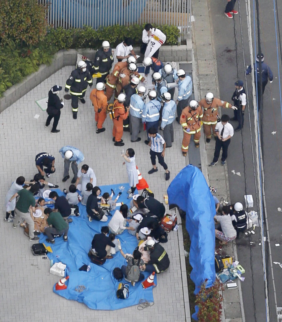 An aerial view shows rescue workers and police officers operate at the site where sixteen people were injured in a suspected stabbing by a man, in Kawasaki.
