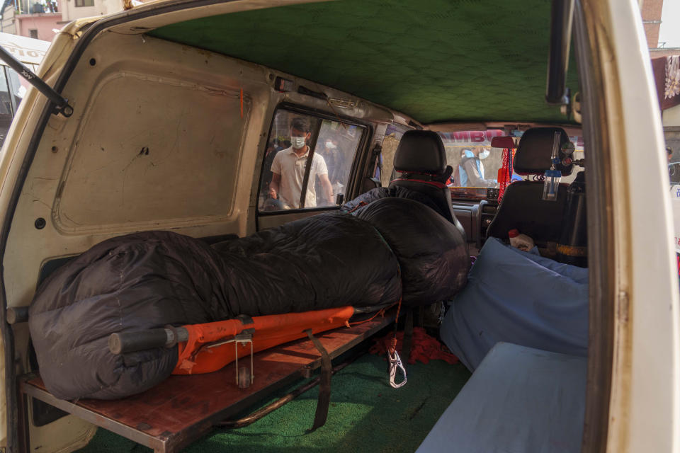 An ambulance carrying the dead body of Irish climber Noel Richmond, 56, brought from Annapurna mountain region is seen in Kathmandu, Nepal, Tuesday, April 18, 2023. An Irish climber died and an Indian is missing after falling into a crevasse in two separate incidents on Mount Annapurna, the world's 10th highest mountain, an expedition organizer said Tuesday. (AP Photo/Niranjan Shrestha)