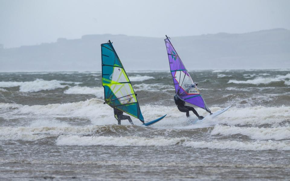 Windsurfers take advantage of the strong gusts from Storm Kathleen