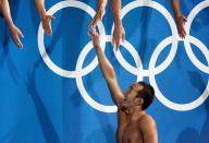 ATHENS - AUGUST 21: Takashi Yamamoto of Japan greets fans after getting the bronze medal for swimming the butterfly leg of the men's swimming 4 x 100 metre medley relay final on August 21, 2004 during the Athens 2004 Summer Olympic Games at the Main Pool of the Olympic Sports Complex Aquatic Centre in Athens, Greece. (Photo by Donald Miralle/Getty Images)