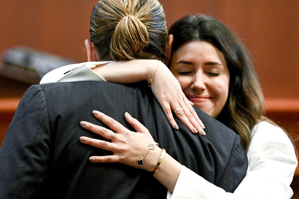 Johnny Depp gets a hug from his attorney, Camille Vasquez, in the courtroom at the Fairfax County Circuit Courthouse. Vasquez has set social media on fire with both her legal acumen and her personal touch with her client.