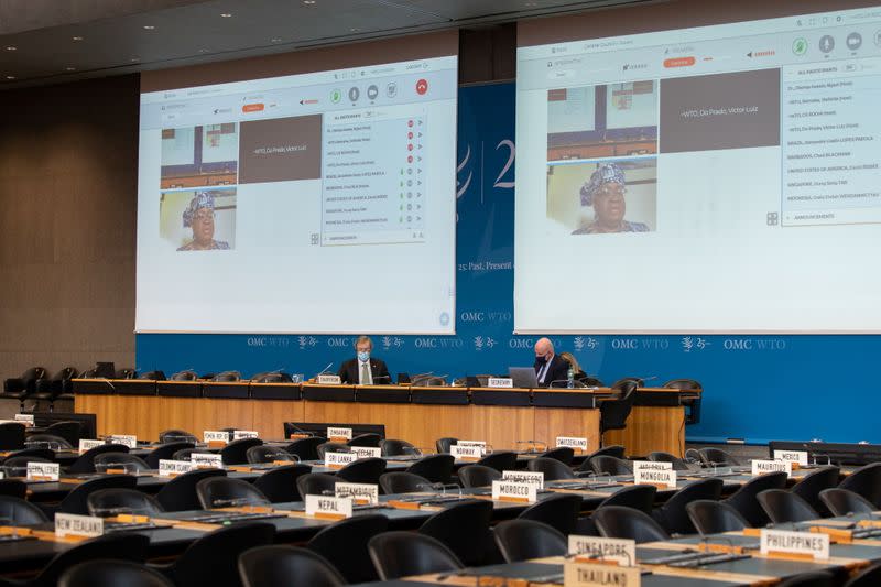 Chairman David Walker addresses the WTO Special General Council as Nigeria's Ngozi Okonjo-Iweala is seen on screen, in Geneva