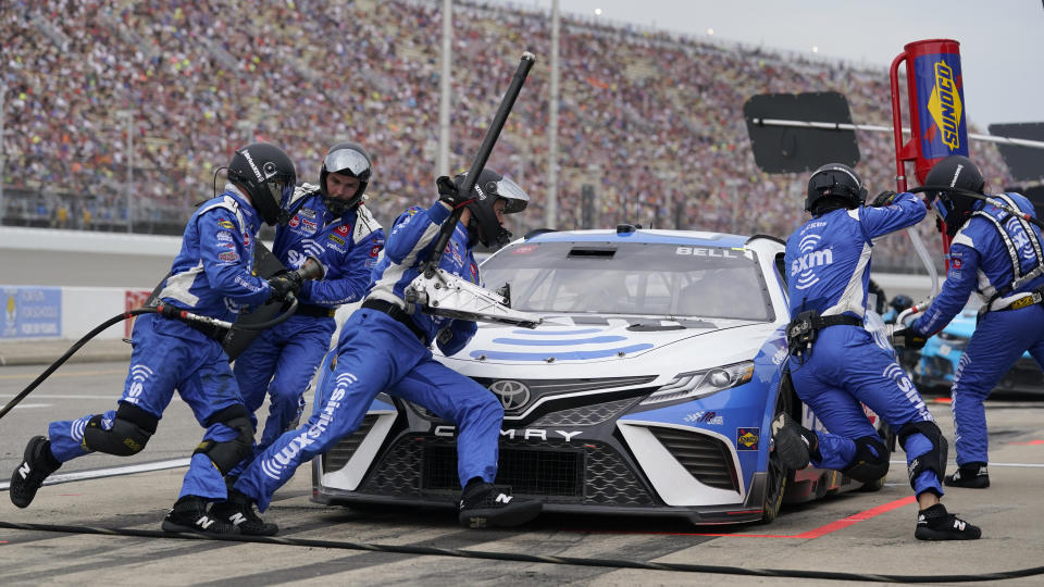 Christopher Bell (20) stops for a pits stop in the NASCAR Cup Series auto race at the Michigan International Speedway in Brooklyn, Mich., Sunday, Aug. 7, 2022. (AP Photo/Paul Sancya)