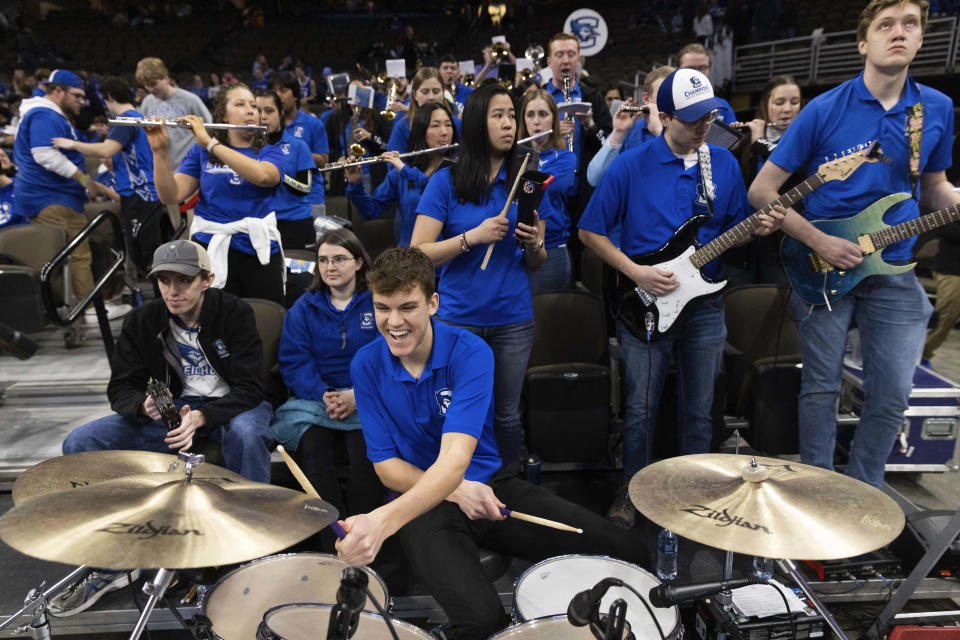 Parker Crouch, front, a Creighton freshman from Holton, Kan., plays the drums with the pep band before Creighton plays St. John's plays in an NCAA college basketball game Saturday, Jan. 13, 2024, in Omaha, Neb. (AP Photo/Rebecca S. Gratz)