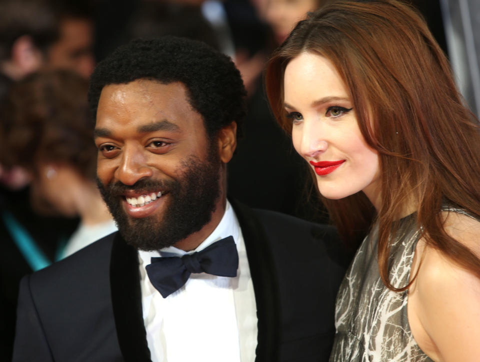 Actors Chiwetel Ejiofor and Sari Mercer pose for photographers on the red carpet at the EE British Academy Film Awards held at the Royal Opera House on Sunday Feb. 16, 2014, in London. (Photo by Joel Ryan/Invision/AP)