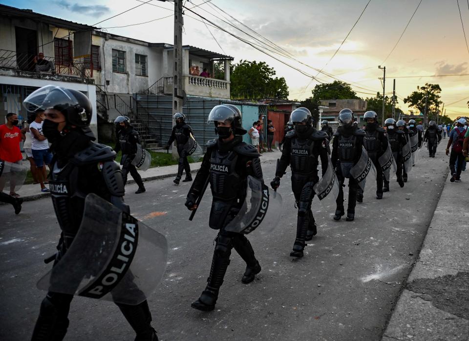 July 12, 2021:  Riot police walk the streets after a demonstration against the government of President Miguel Diaz-Canel in Arroyo Naranjo Municipality, Havana. 
Cuba on Monday blamed a "policy of economic suffocation" of United States for unprecedented anti-government protests, as President Joe Biden backed calls to end "decades of repression" on the communist island.  Thousands of Cubans participated in Sunday's demonstrations, chanting "Down with the dictatorship," as President Miguel Díaz-Canel urged supporters to confront the protesters.