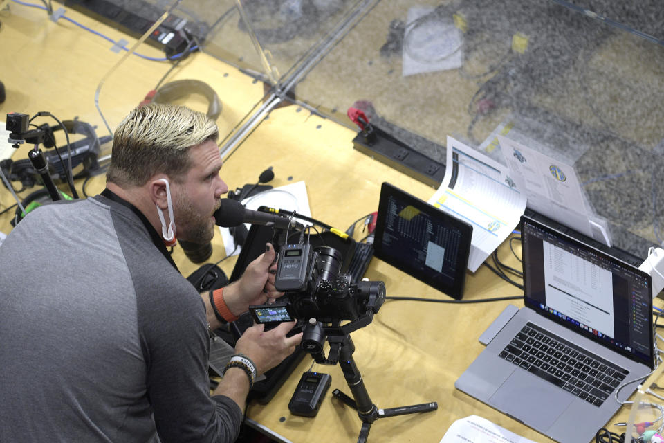 Public address announcer Matt Pittman introduces Chicago Sky player as they enter the court before a WNBA basketball game against the New York Liberty, Tuesday, Aug. 25, 2020, in Bradenton, Fla. Performing in the WNBA bubble at games presents a new experience for DJs and announcers since there are only a handful of people in attendance at games besides the players. (AP Photo/Phelan M. Ebenhack)