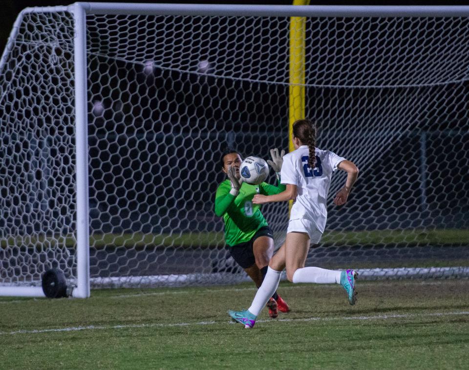 Mariner's Mariam Quintanilla gets the save as Naples' Valentina Hauser runs to the box during Friday's Region 5A-3 semifinal.