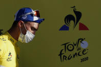 France's Julian Alaphilippe, wearing the overall leader's yellow jersey arrives on podium after winning the second stage of the Tour de France cycling race over 186 kilometers (115,6 miles) with start and finish in Nice, southern France, Sunday, Aug. 30, 2020.(Sebastien Nogier/Pool photo via AP)