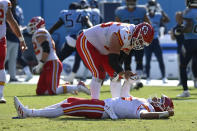 Kansas City Chiefs quarterback Patrick Mahomes is helped up by Mike Remmers (75) after Mahomes was hit in the second half of an NFL football game against the Tennessee Titans Sunday, Oct. 24, 2021, in Nashville, Tenn. (AP Photo/Mark Zaleski)