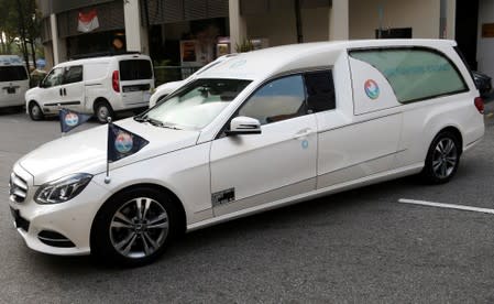 A hearse carrying the body of the late former Zimbabwe President Robert Mugabe leaves the funeral parlour for the airport in Singapore