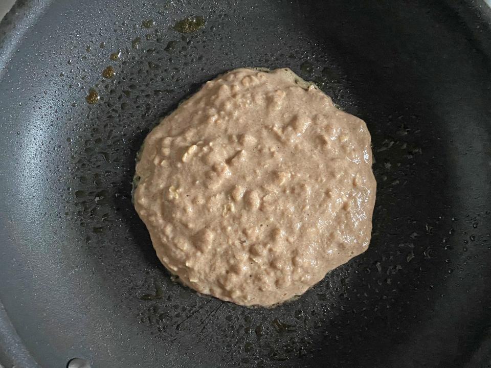 A kodiak pancake cooking in a pan
